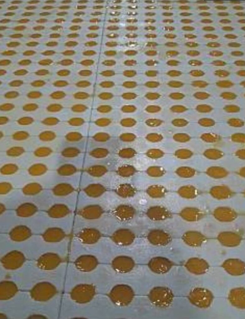 Depositing fruit gummy mixture into cube molds